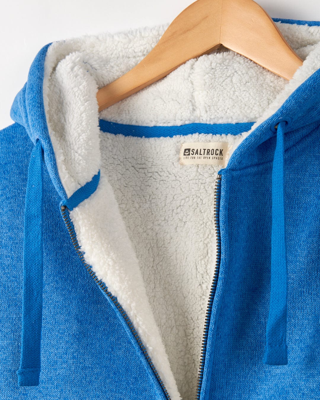 Galak - Womens Fur Lined Hoodie - Blue fleece jacket by Saltrock on a wooden hanger.