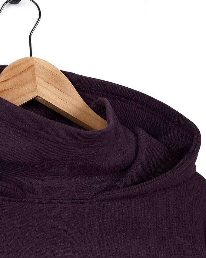 A Saltrock Geo Peak - Mens Oversized Snood Pop Hoodie - Dark Purple hangs on a wooden hanger.