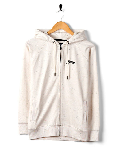 A Saltrock Ginny - Womens Zip Hoodie - Cream in speckled white multi-coloured nep fabric with drawstrings and a cursive logo on the left chest area, displayed on a hanger against a white background.