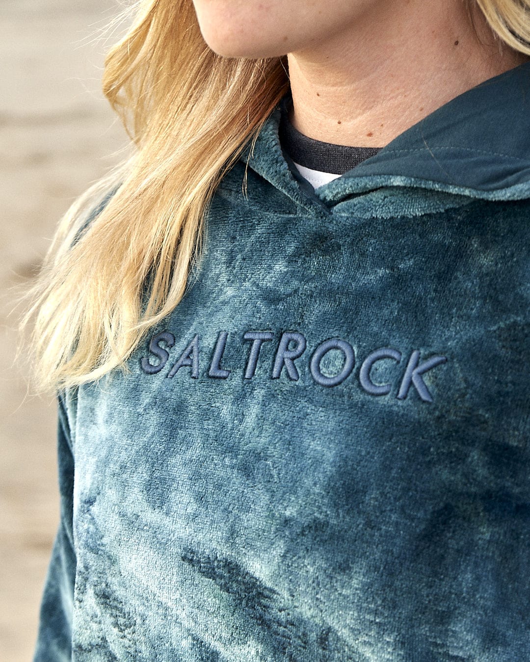 A woman wearing a Gracie - Womens Tie Dye Velour Pop Hoodie - Dark Green from Saltrock.