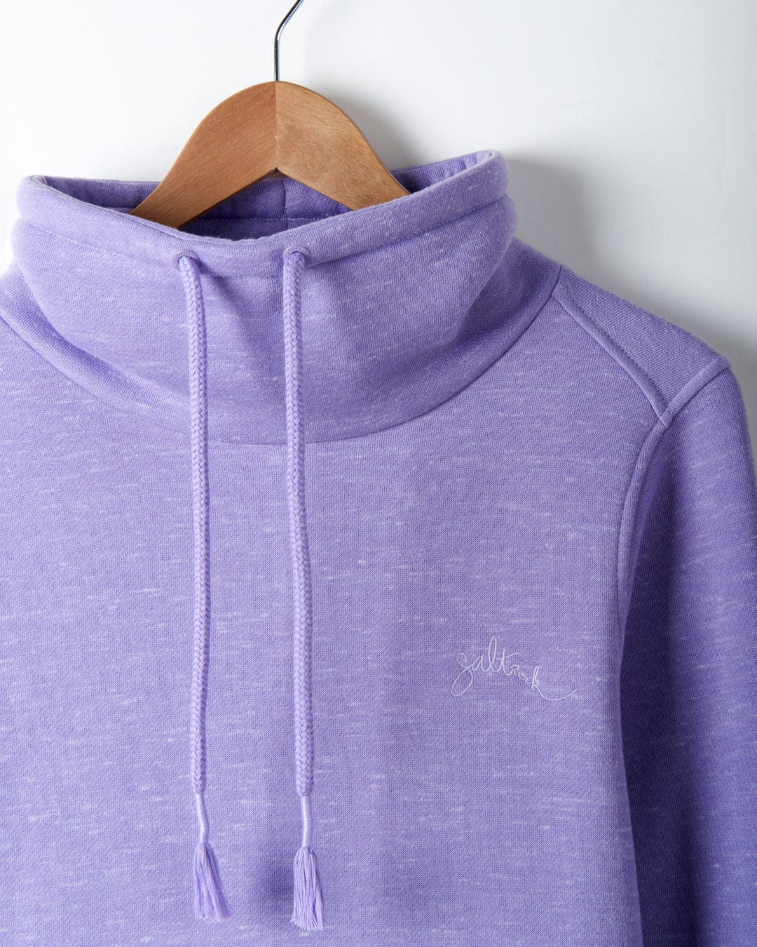 A Harper - Womens Longline Pop Sweat - Lilac sweatshirt from Saltrock, machine washable and longline, hanging on a hanger.