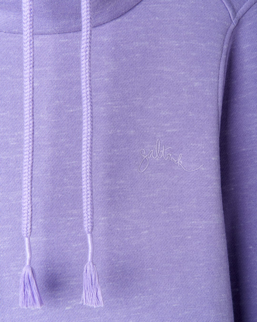 A close up of a lilac Saltrock Harper Womens Longline Pop Sweat hoodie with tassels, embroidered branding, and longline design.