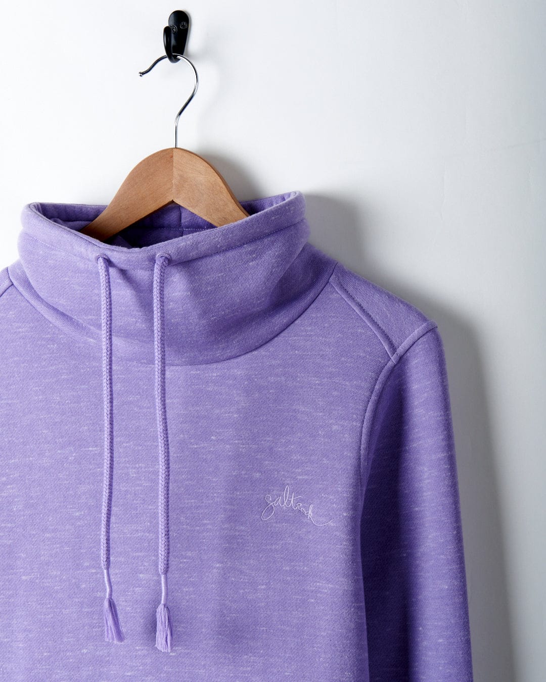 A Harper - Womens Longline Pop Sweat - Lilac with Saltrock embroidered branding hanging on a hanger.