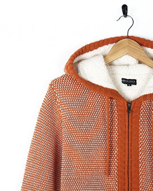 A Saltrock - Womens Borg Lined Knitted Hoodie - Orange and white hanging on a hanger.
