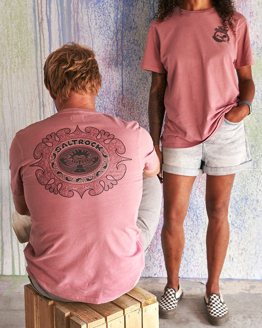 A man and a woman wearing a Saltrock Heraldic Tok - Limited Edition 35 Years T-Shirt.