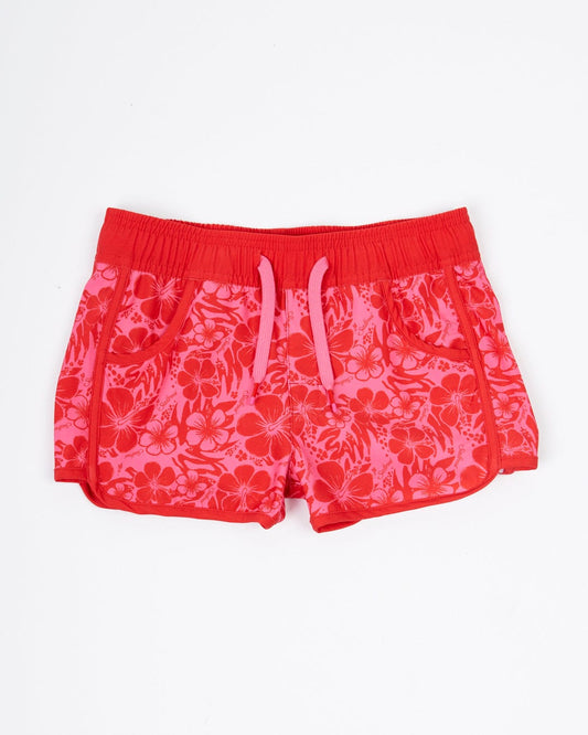 A pair of pink shorts made from Saltrock's Hibiscus - Kids Boardshorts - Red/Pink, which is made from Repreve recycled material.