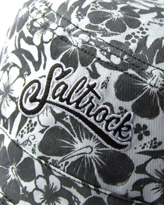 Close-up of a cotton hat with the Saltrock logo and Hibiscus Bucket Hat - Washed Black embroidered on the front.