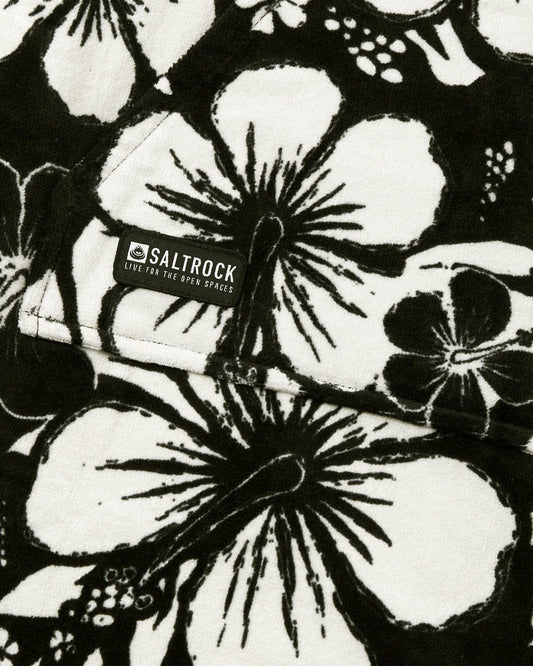 Close-up of a black and white floral patterned 100% cotton towelling fabric with a Saltrock label.
