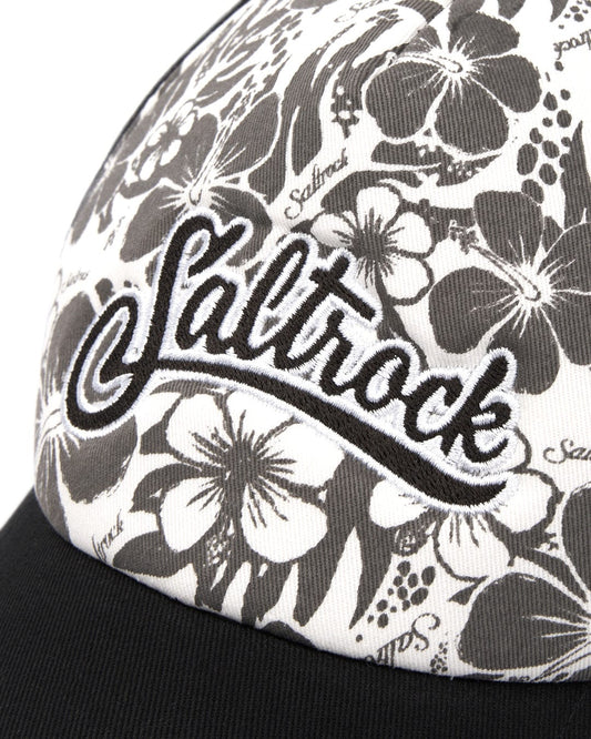 Close-up of a Hibiscus Trucker Cap - Black with the embroidered Saltrock branding on it.