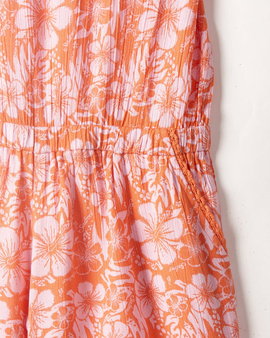 Close-up of a Saltrock pink/orange hibiscus kids playsuit with a gathered waist detail.