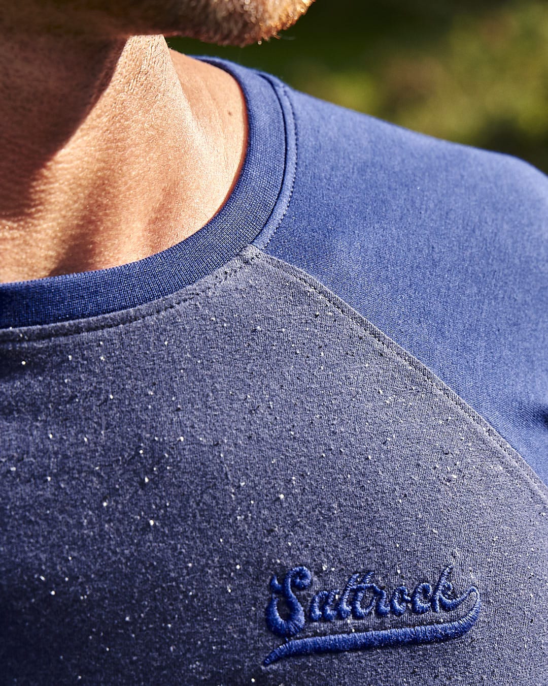 A man wearing a blue Saltrock Home Run Nep - Mens Raglan Long Sleeve T-Shirt.