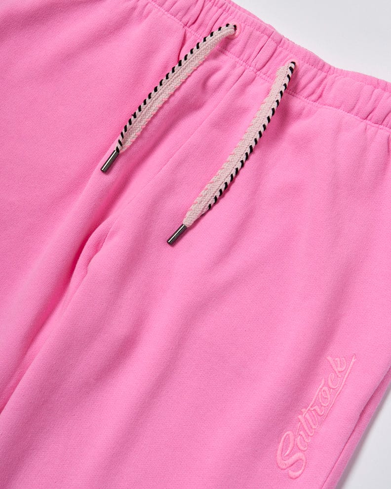 Close-up of Saltrock Instow - Womens Jogging Bottom - Pink with an elasticated waistband and embroidered text "saturée" on the front.