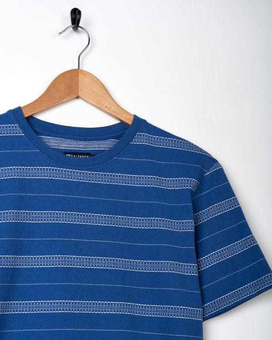 A Jacques - Mens Short Sleeve T-Shirt - Blue made of cotton is hanging on a hanger.