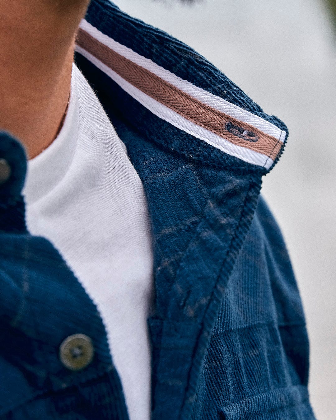 A close up of a man wearing a Saltrock Jaxon - Mens Check Long Sleeve Shirt - Dark Blue.