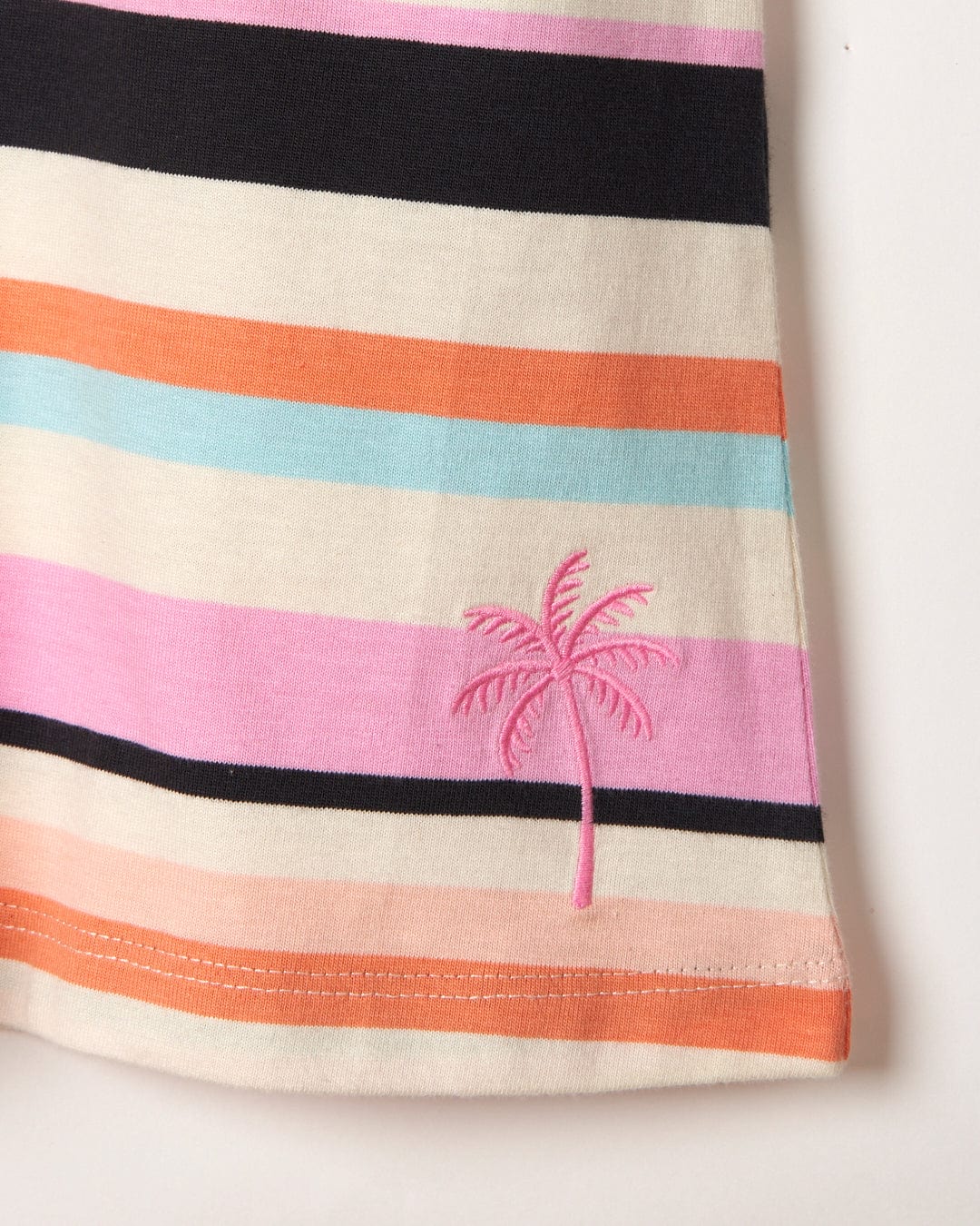 A Juno Bauhaus striped cotton skirt with a palm tree embroidered on it.