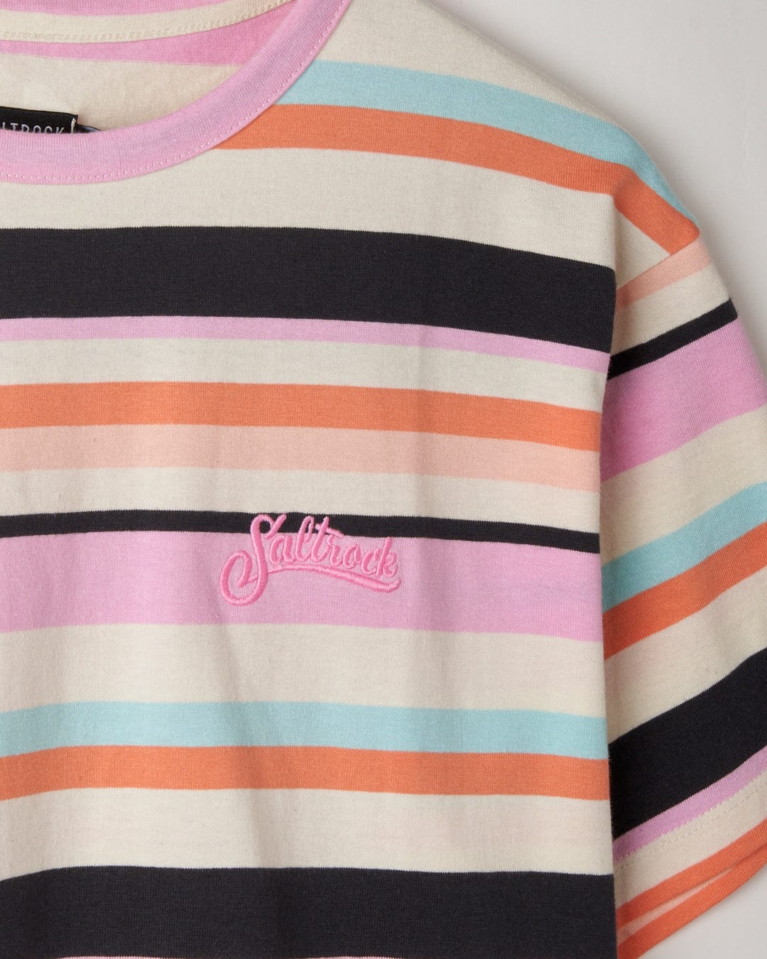 Close-up of a striped cotton Juno - Womens Short Sleeve T-Shirt - Multi with the brand 'Saltrock' embroidered on it.
