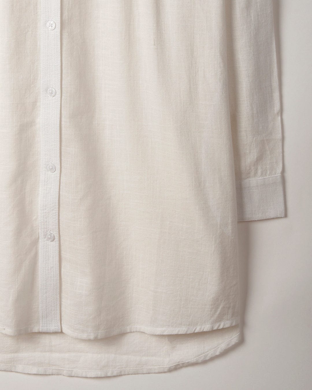 Close-up of a Saltrock Karthi - Womens Long Sleeve Shirt - White with visible texture, focusing on the button placket and hem.