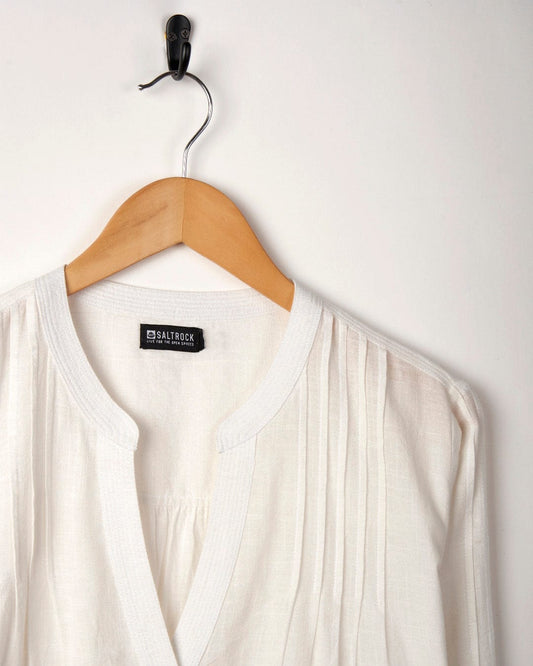 Saltrock White cotton blouse with pleated detail, hanging on a wooden hanger against a plain background.