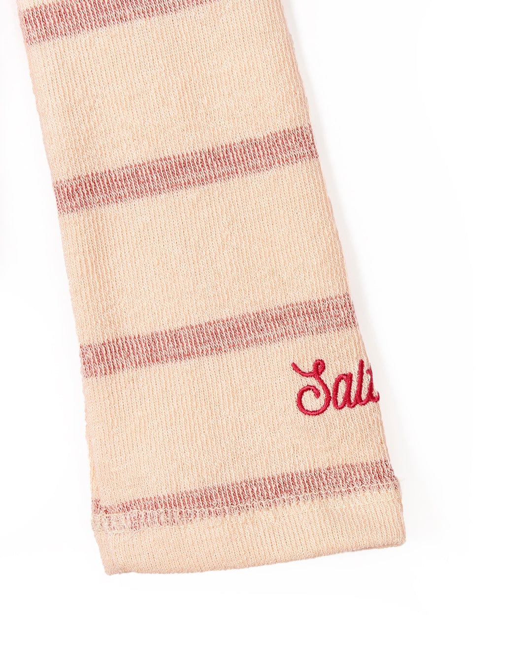 A Kennedy - Kids Pop Hoodie - Coral Saltrock sock with the word salud written on it.