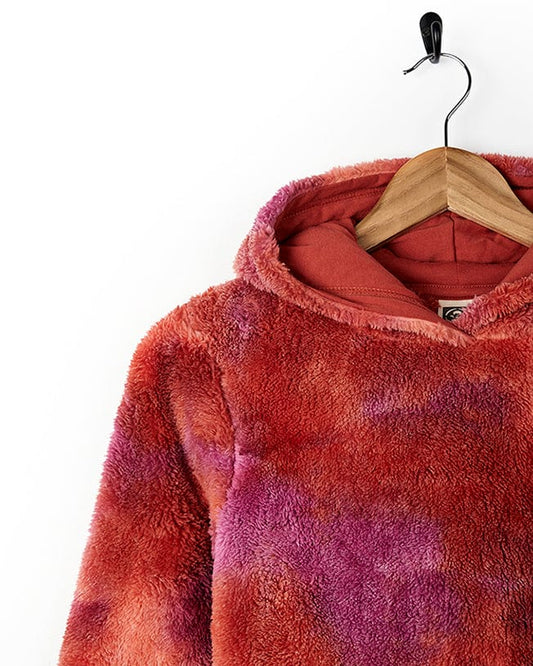 A trendy and stylish Kiki Pop - Girls Tie Dye Fur Pop Hoodie - Red by Saltrock with a cozy fur lining hanging on a hanger.
