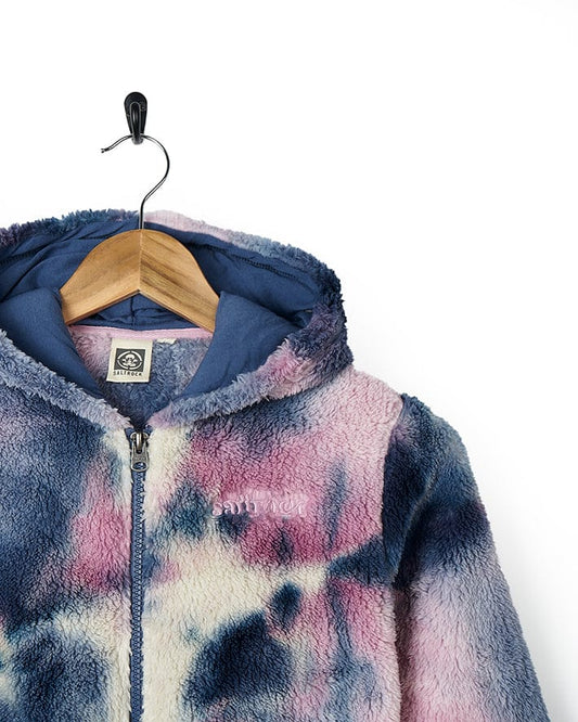 A girl's Kiki - Kids Tie Dye Fleece Zip Hoodie - Pink/blue by Saltrock hanging on a hanger.