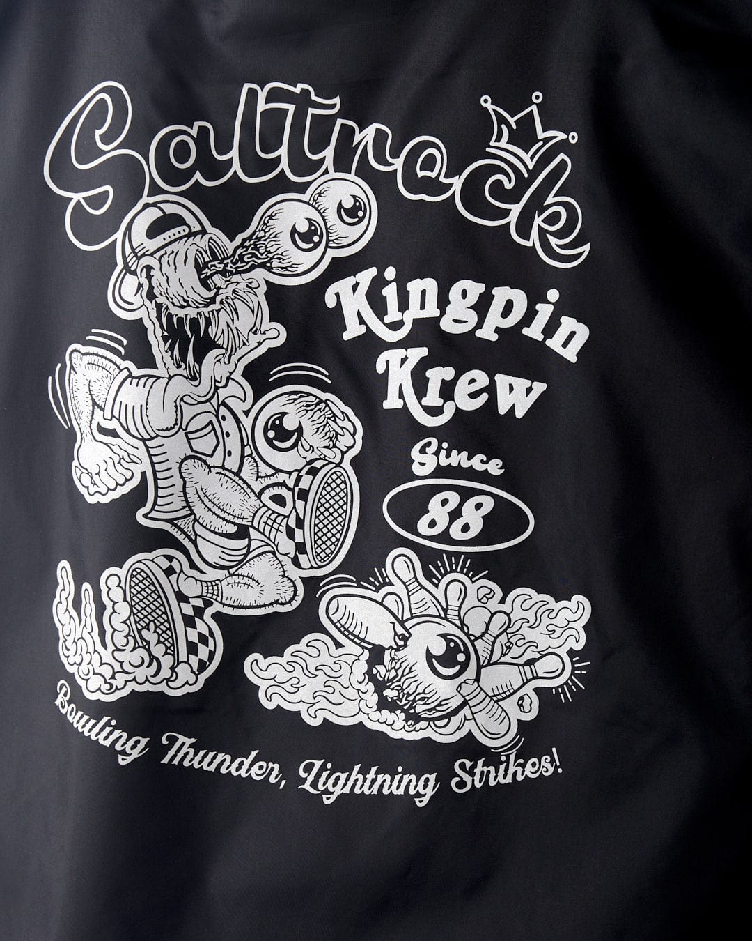 Black t-shirt featuring the "Kingpin Krew - Kids Coach Jacket - Black" white graphic with cartoonish characters bowling and the text "bowling thunder, lightning strikes!", now enhanced with a fleece-lined.