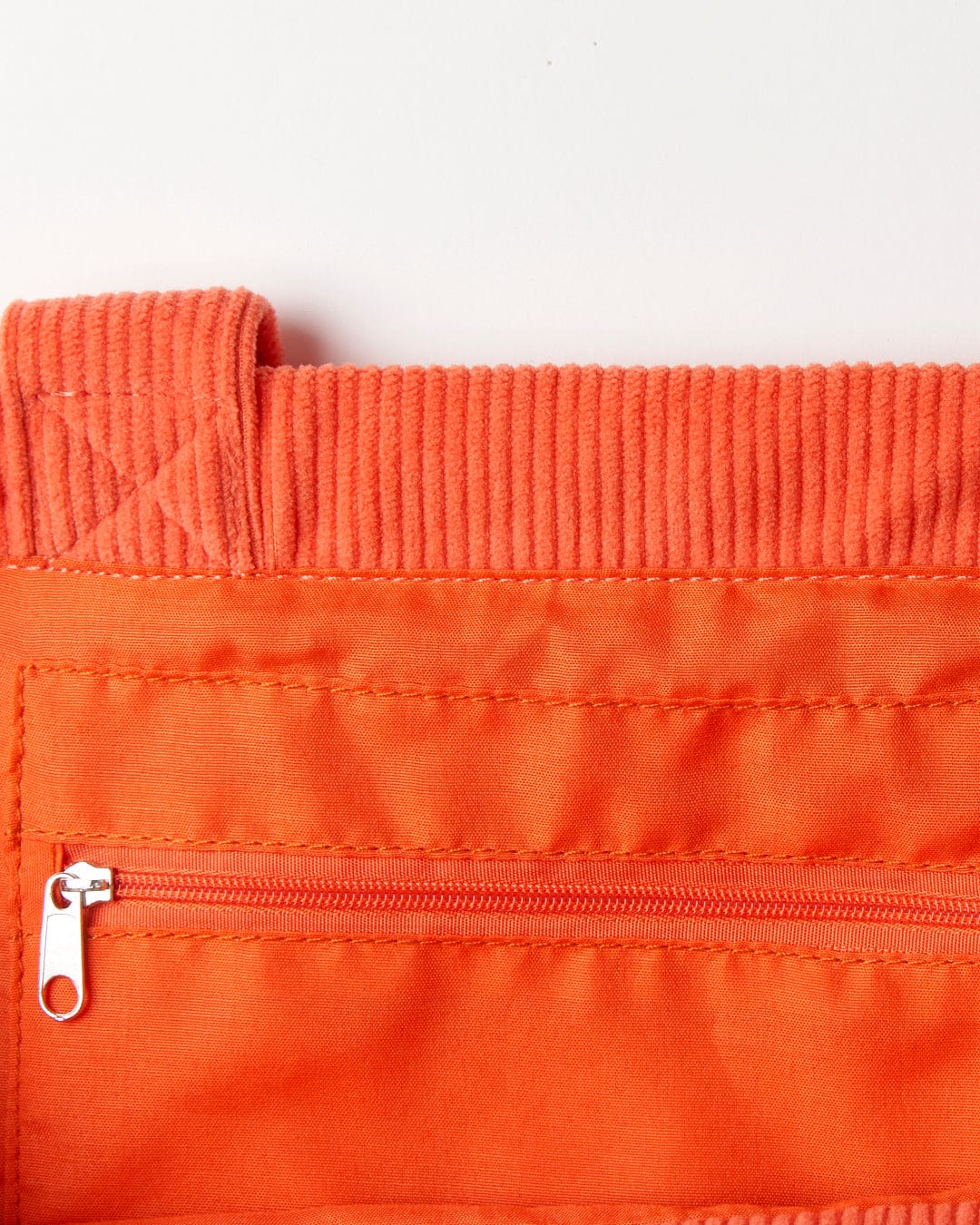 Close-up of a Saltrock Laguna Cord Shopper Bag - Coral with shoulder straps, a zipper, and textured waistband.