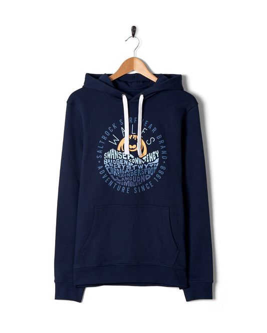 A blue hoodie with a **chest print** of the ocean on it. - A blue Layers Wales - Mens Pop Hoodie from Saltrock with a chest print of the ocean on it.