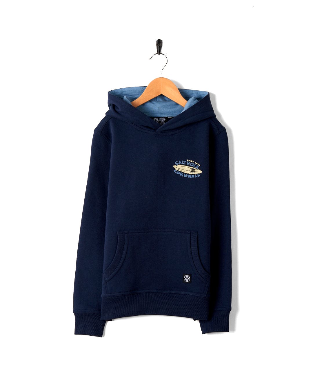 A Lazy Location Cornwall - Recycled Kids Hoodie - Blue with a front pocket and a hood, hanging on a hanger against a white background. The hoodie has a small Saltrock branded logo on the chest.