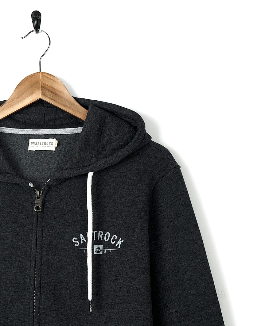 A dark grey zip up hoodie with the word Saltrock on it.
