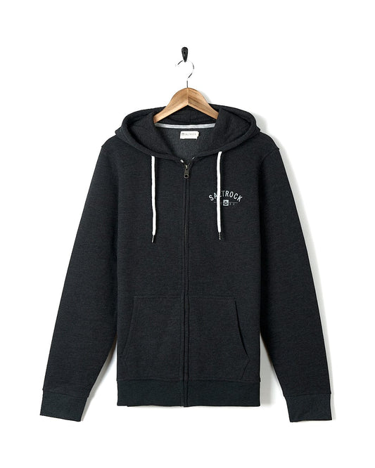 A Saltrock Location Zip Hoodie - Woolacombe - Dark Grey with a white logo on it.
