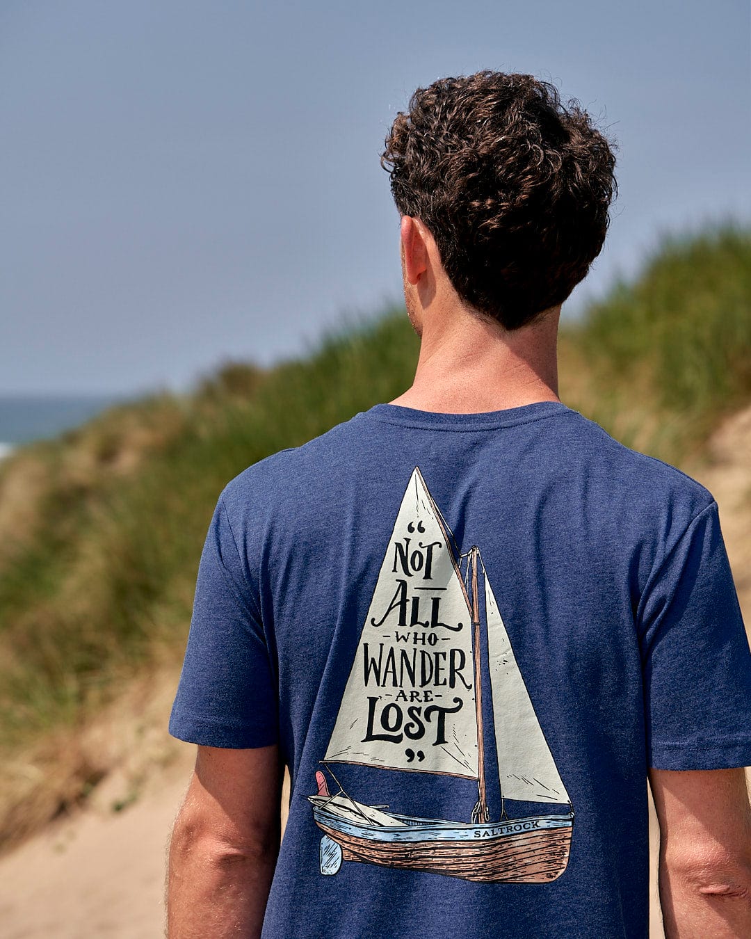 The back of a man wearing a Saltrock Lost Ships - Mens Short Sleeve T-Shirt - Blue.