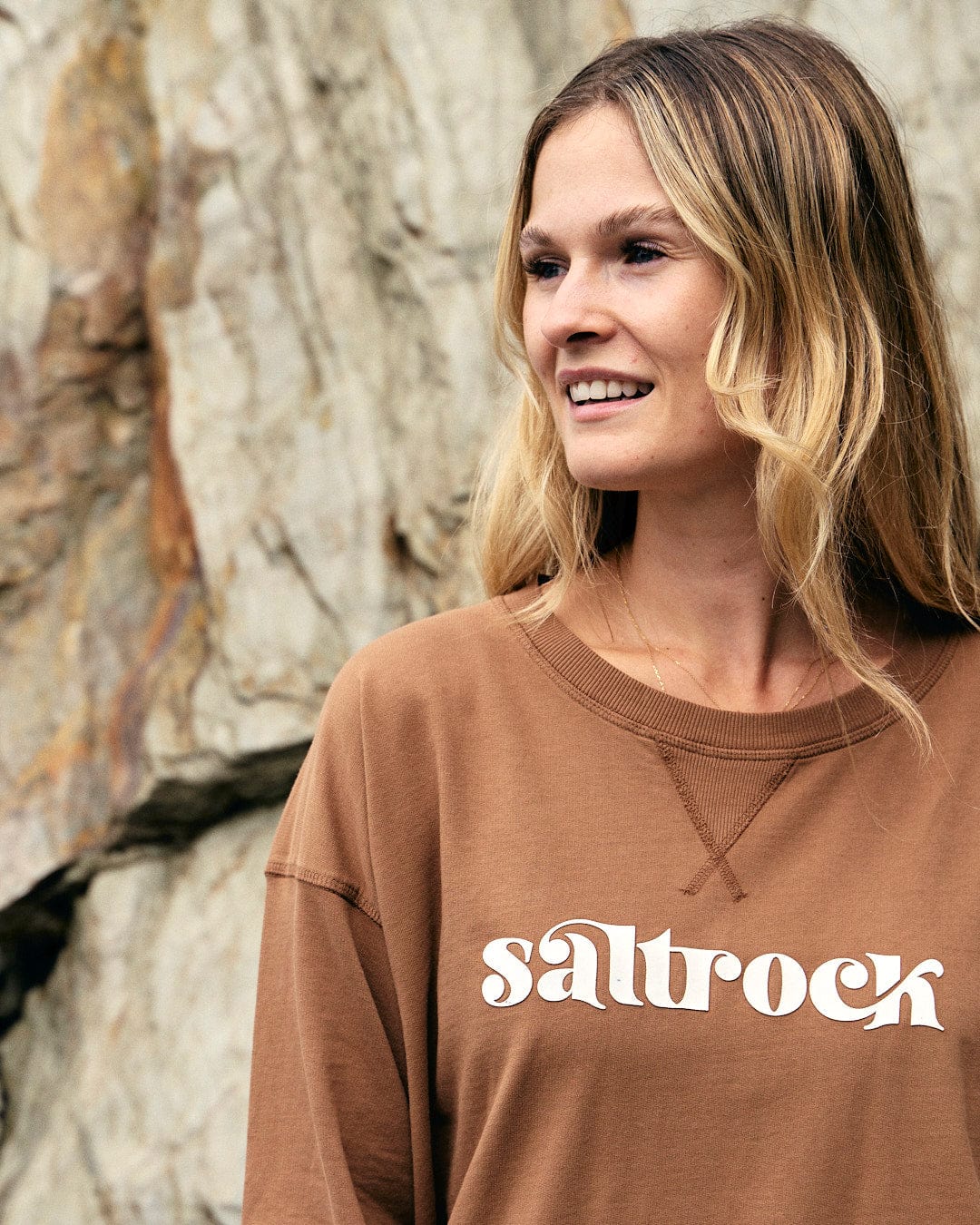 A woman wearing a Saltrock Louisa - Womens Crew Sweat - Brown sweatshirt.