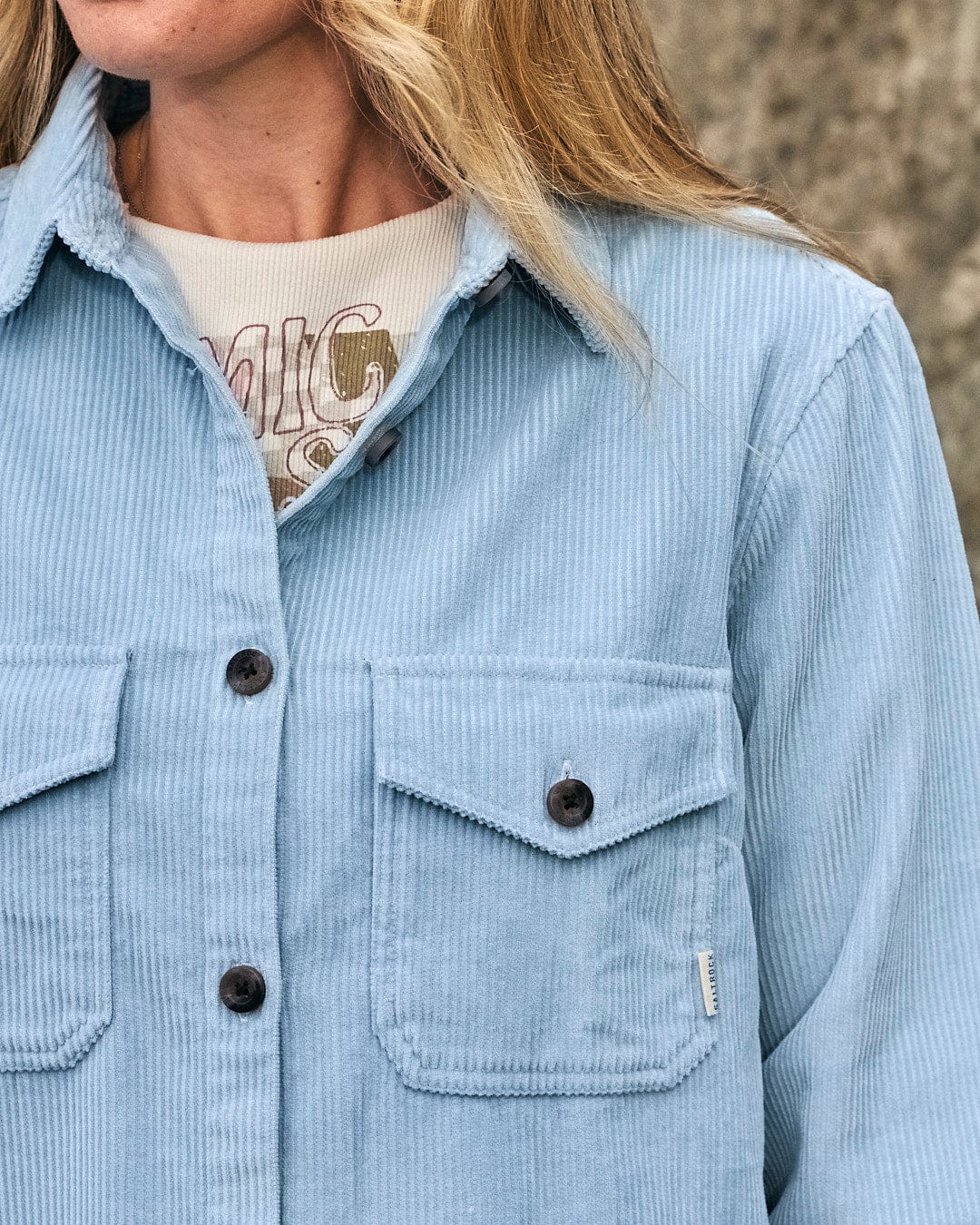 A woman wearing a light blue corduroy Saltrock Maddox - Womens Cord Shirt.