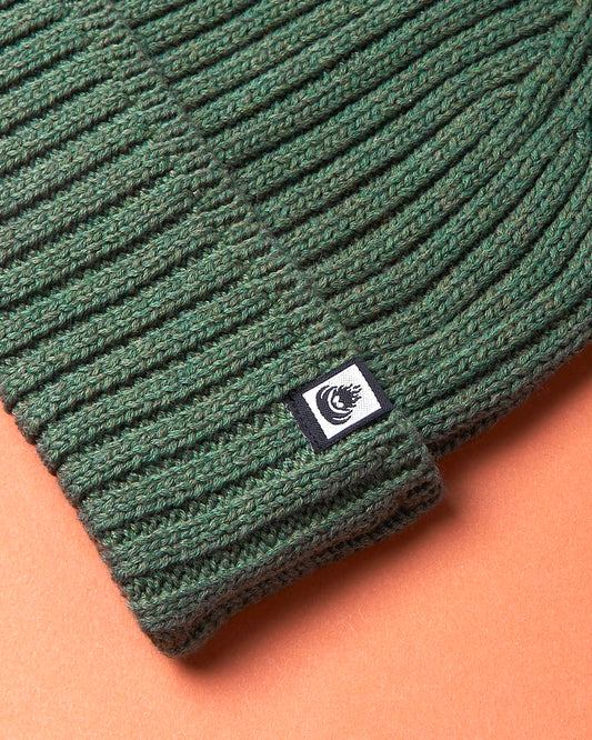 A Maine - Fisherman Beanie - Green by Saltrock on a brown background.