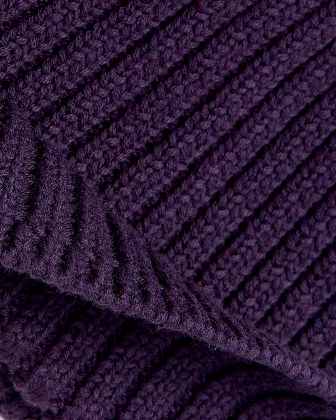 A close up image of a Saltrock Maine - Fisherman Beanie - Dark Purple.