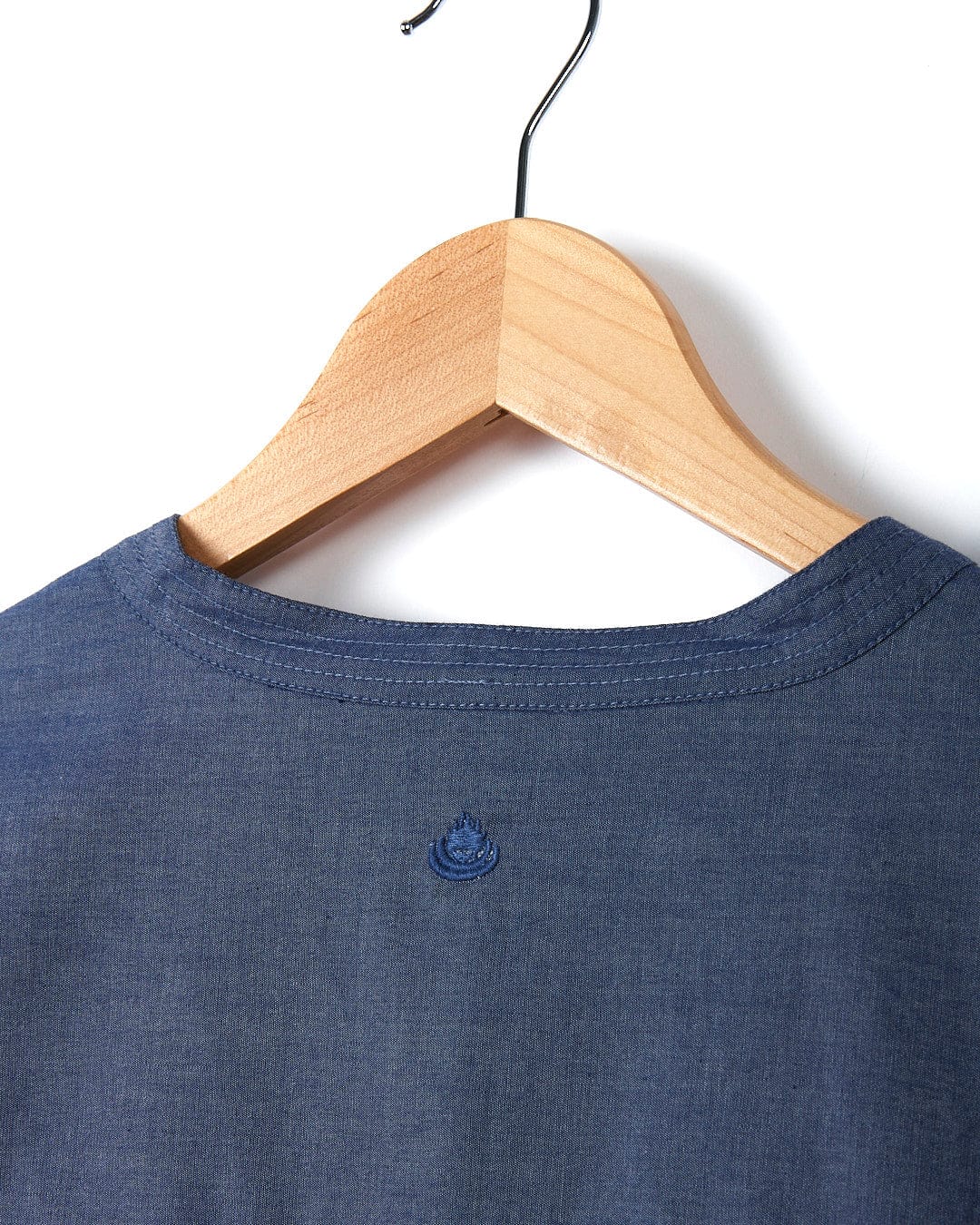 The back of a Saltrock Manina - Womens Beach Shirt - Blue hanging on a wooden hanger.