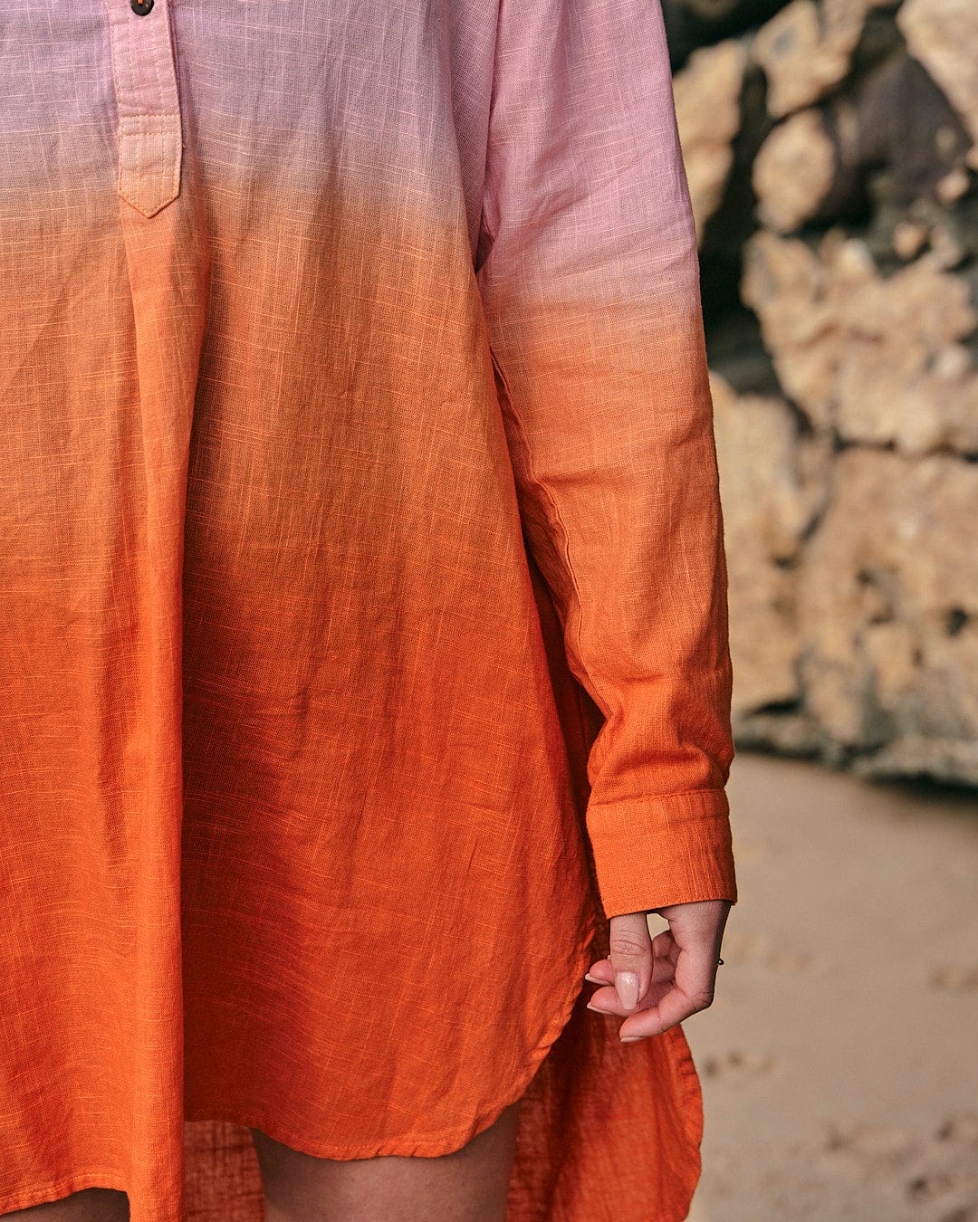 A woman wearing the Saltrock Manina - Womens Dip Die Beach Shirt - Orange.