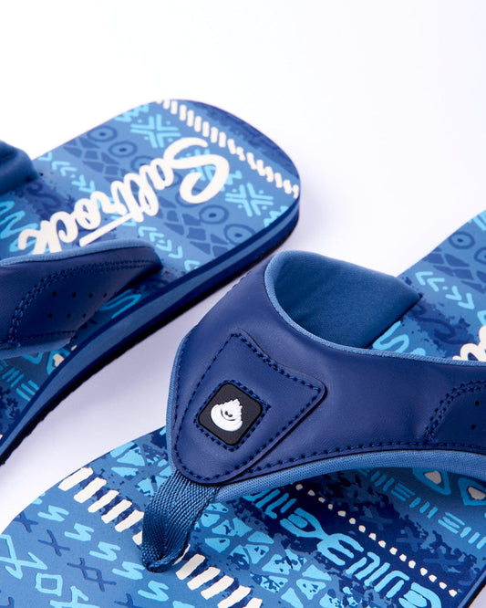 A pair of blue Saltrock sandals with patterned soles and Saltrock branding on the strap, displayed on a white background.