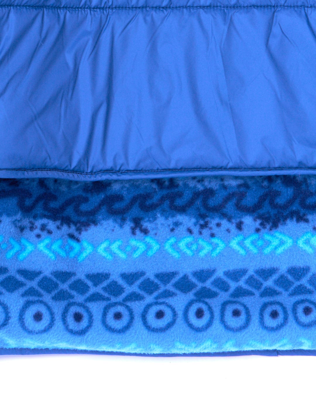 A close up of a Saltrock - Marks Unisex Recycled Reversible Poncho - Blue sleeping bag with a reversible hood.