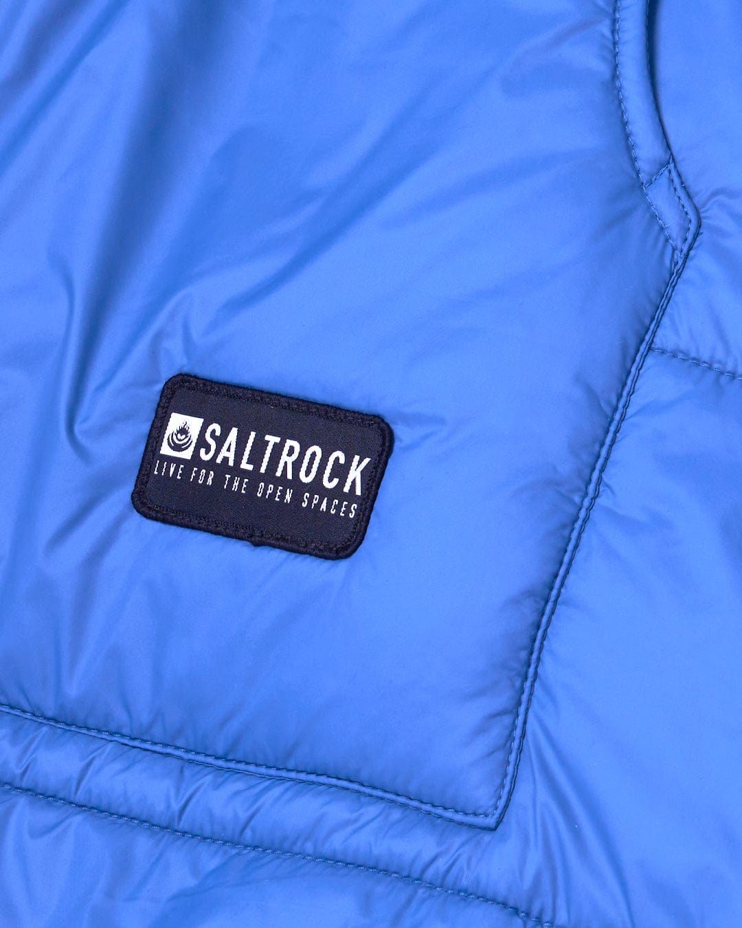 A close up of a Saltrock - Marks Unisex Recycled Reversible Poncho - Blue jacket made from recycled material.