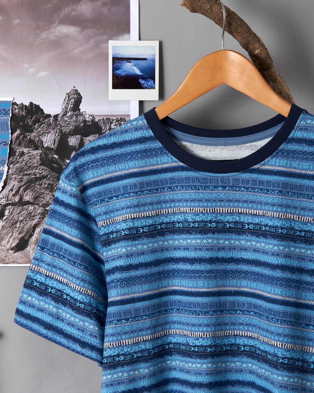A Saltrock Marks - Mens Short Sleeve T-Shirt - Blue hanging on a wall.