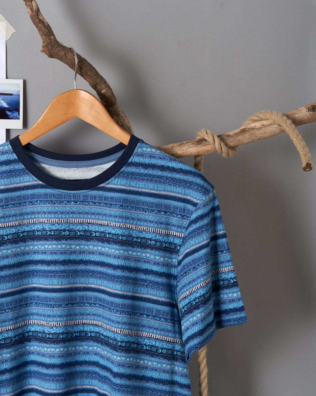 A blue striped Marks - Mens Short Sleeve T-shirt with Saltrock branding hanging on a branch.