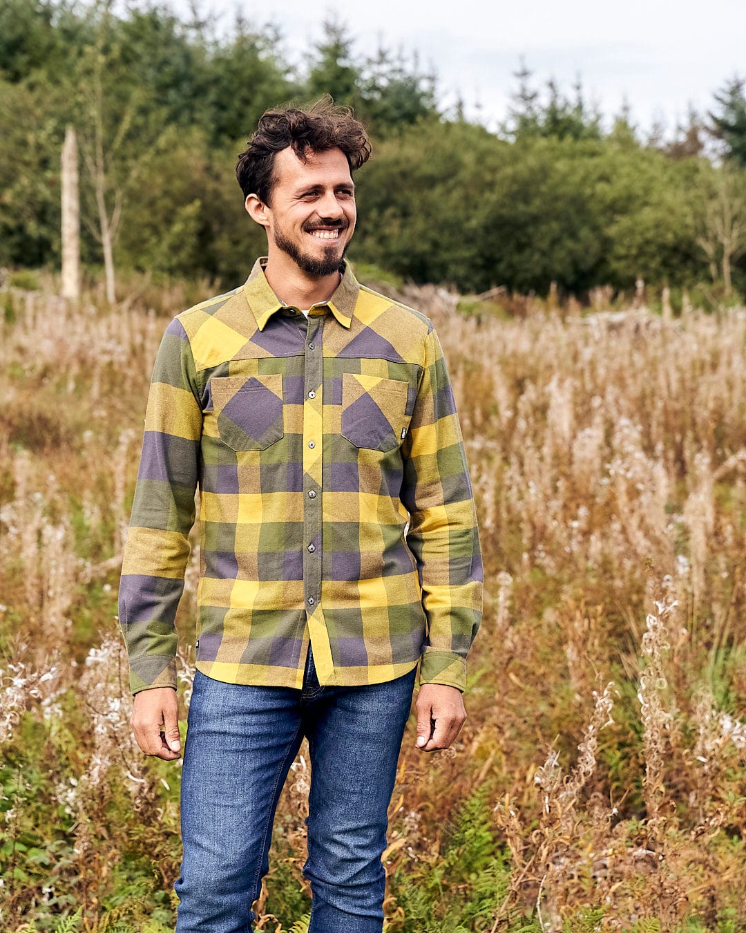 A man in a Saltrock Mattie - Mens Long Sleeve Shirt - Yellow standing in a field.