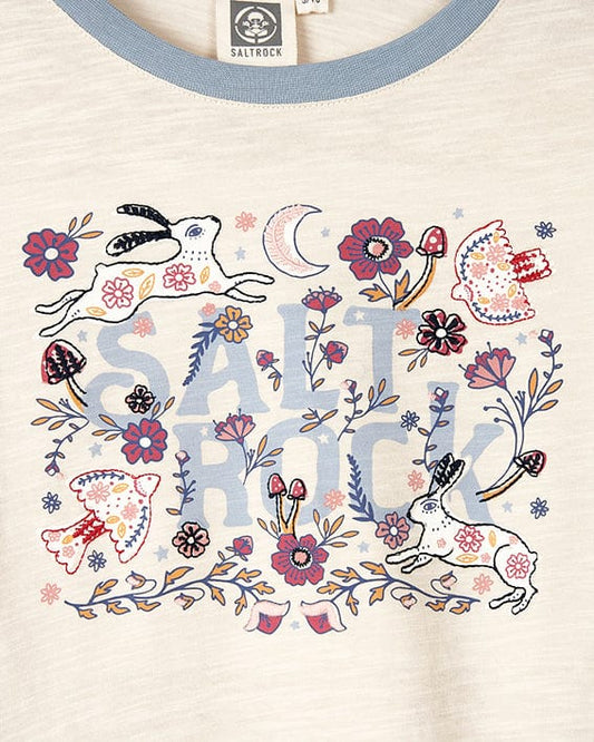 A comfortable Meadow - Kids Long Sleeve Cropped T-Shirt - Cream by Saltrock with an embroidered floral illustration of a rabbit and flowers.