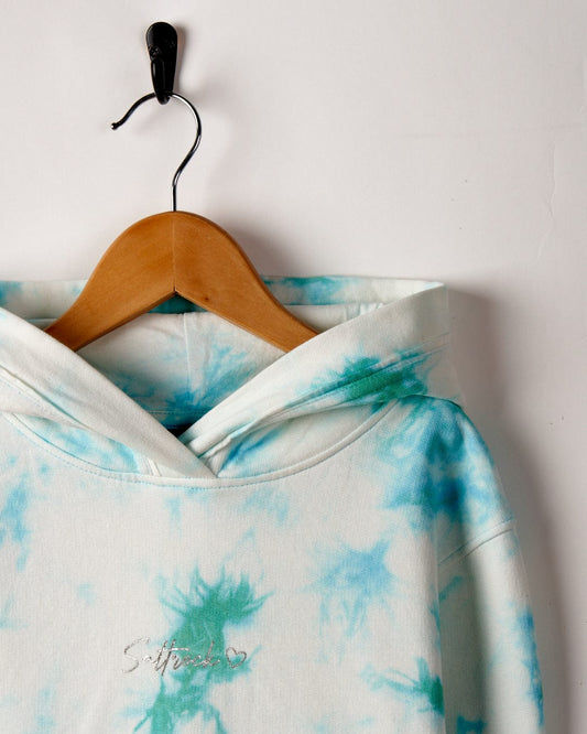 A Saltrock Mermaid Surf - Kids Tie Dye Pop Hoodie in shades of blue and green, displayed on a wooden hanger against a white background.
