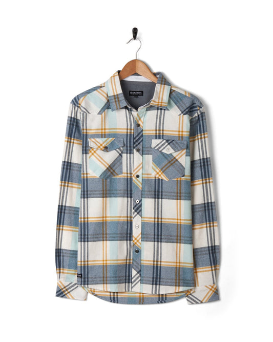 Miles - Mens Long Sleeve Shirt - Blue check flannel shirt by Saltrock hanging on a coat hanger against a white background.