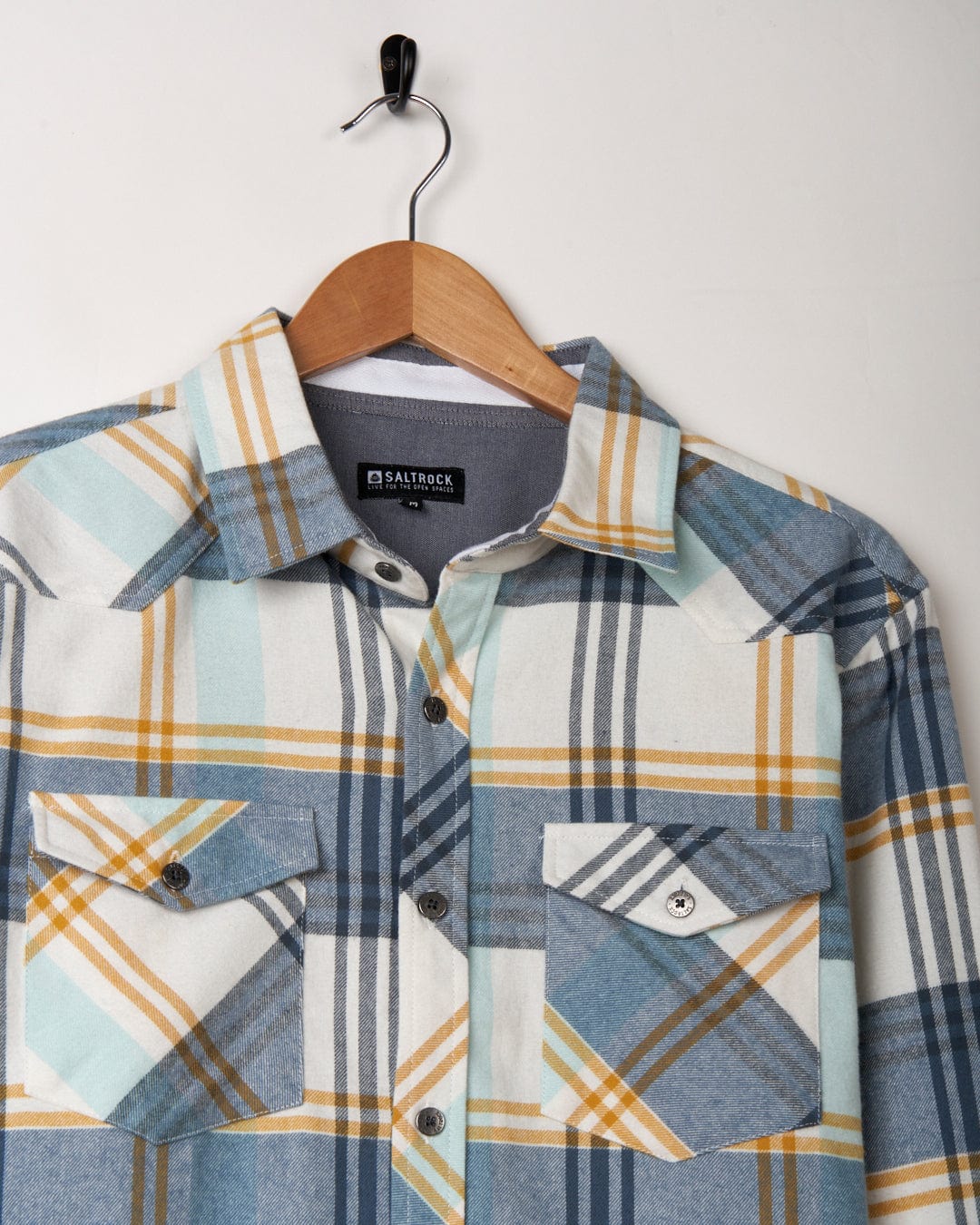 Saltrock Miles - Mens Long Sleeve Shirt - Blue on a hanger against a white background.
