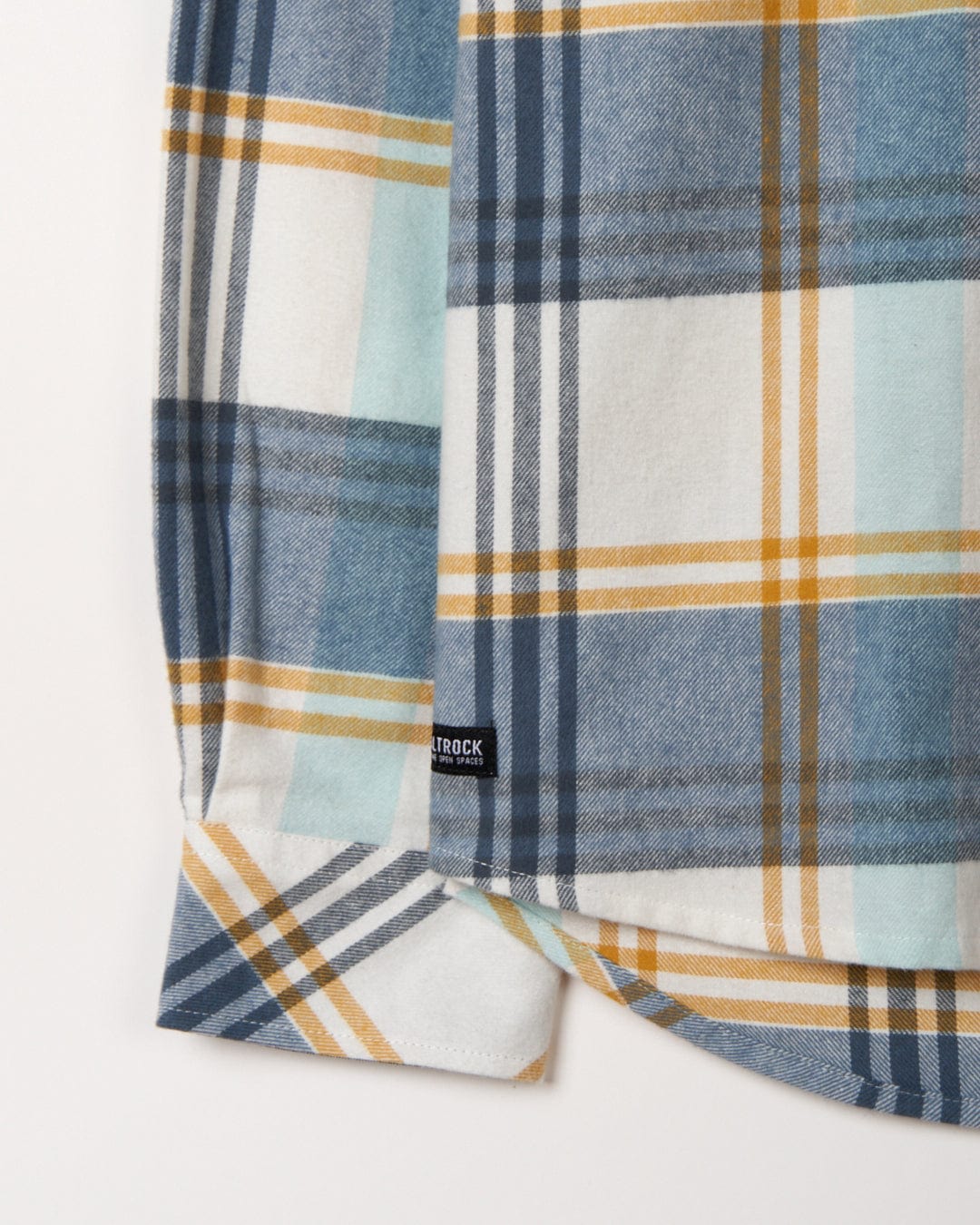 Plaid flannel fabric with a 'Miles' label on a white background.