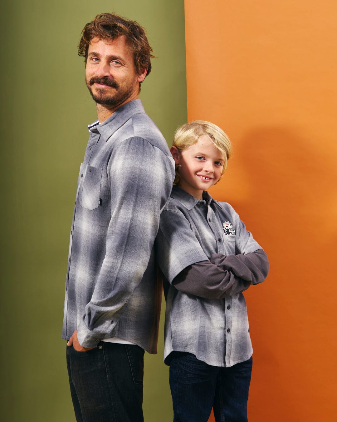 A man and a boy standing next to each other wearing Saltrock Slacker Kids Shirts.